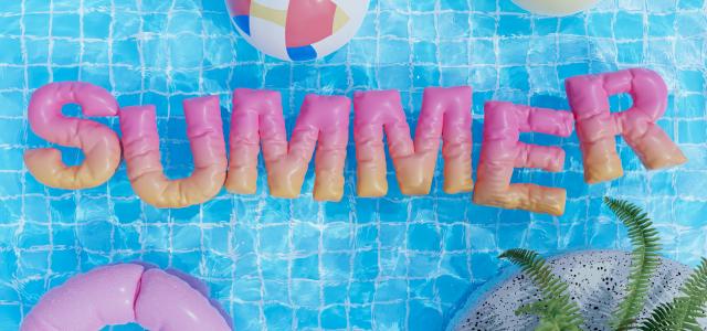 a pool with a pool float, inflatable toys, and the word summer by Warren Umoh courtesy of Unsplash.